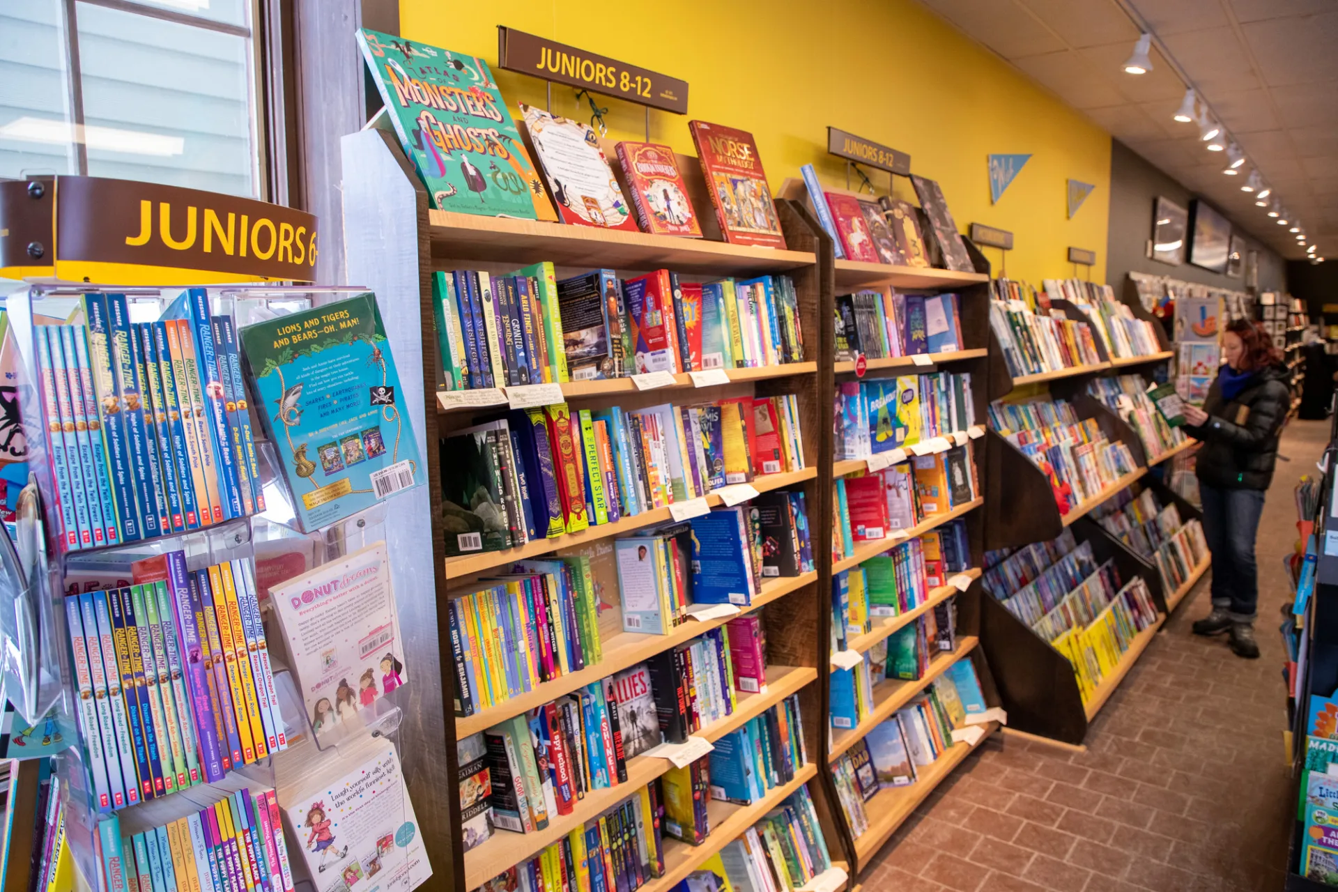 Rows of children's books on bookshelves in bookstore