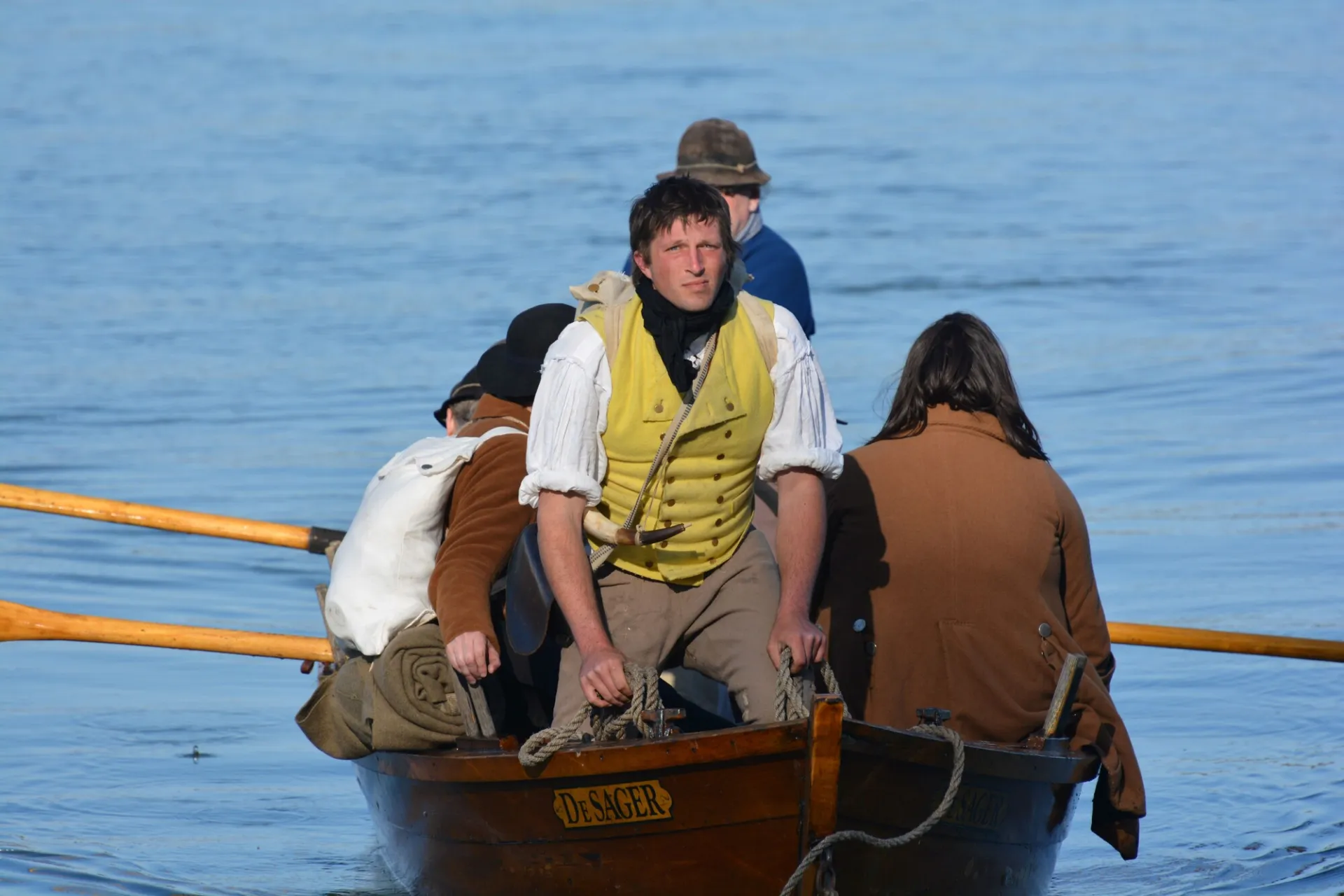 Revolutionary war reenactors float on a small boat