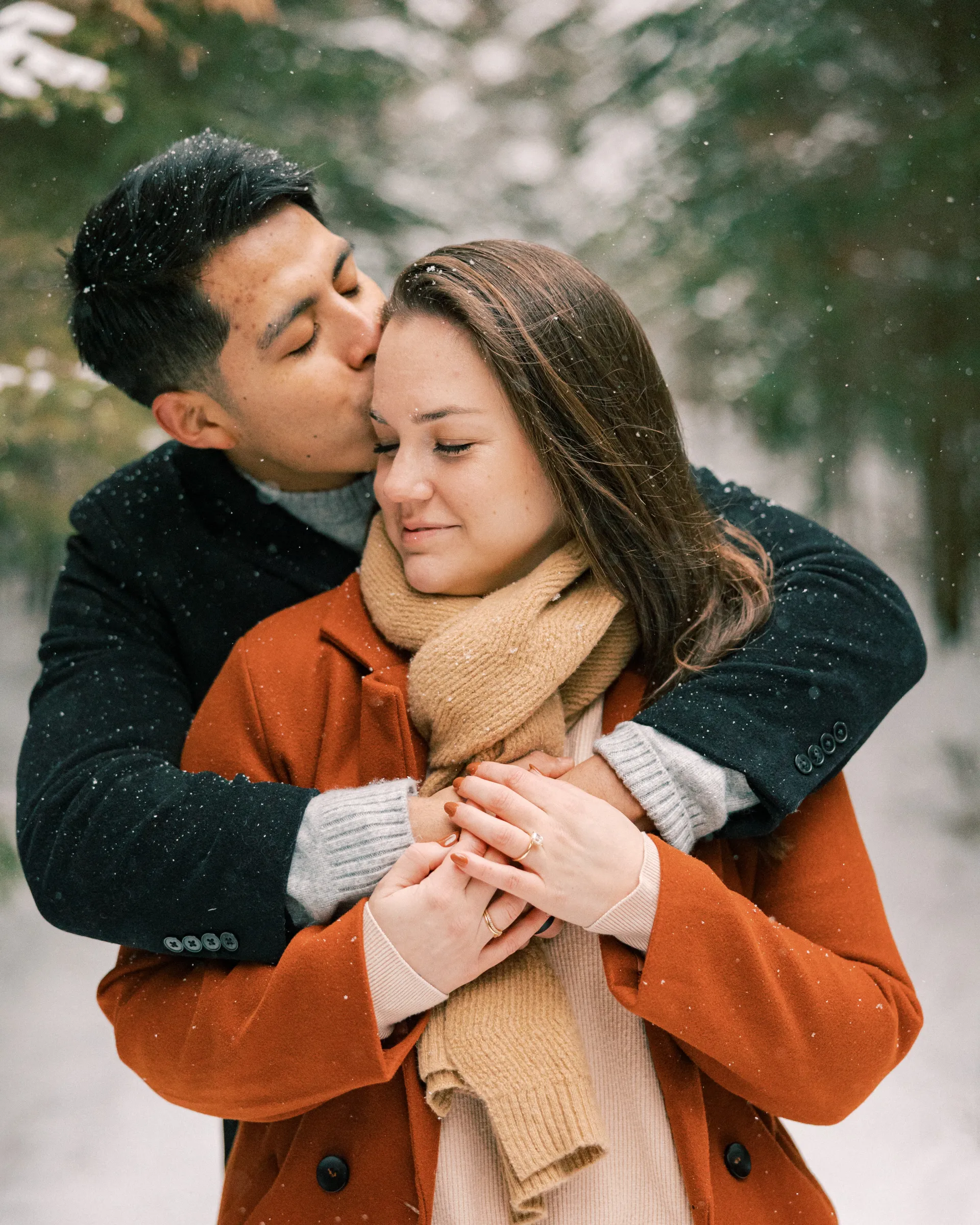 A couple embraces in the snow