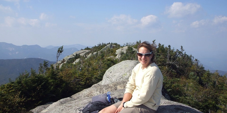 Celebrating the summit of Dix Mountain on a summer day.