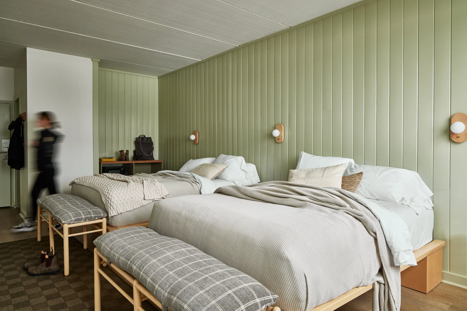 Two queen beds in a mint colored room.