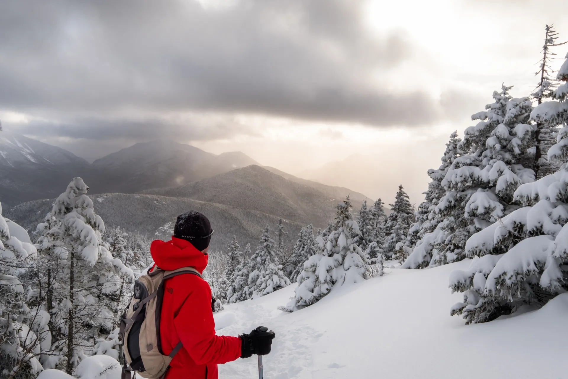 Winter hiker taking in big mountain views