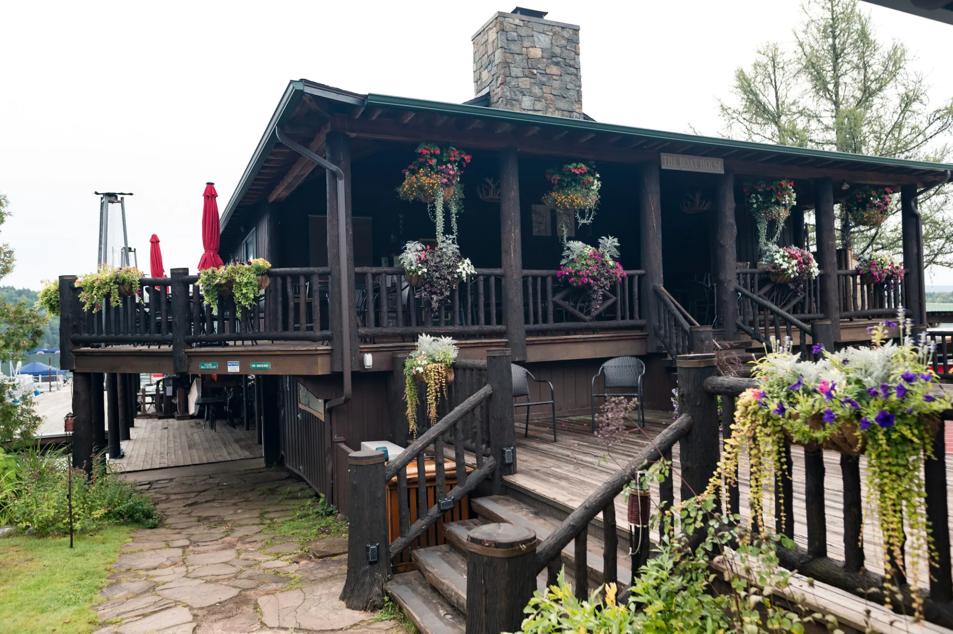 Moose Lodge Boathouse in summer with hanging baskets of flowers