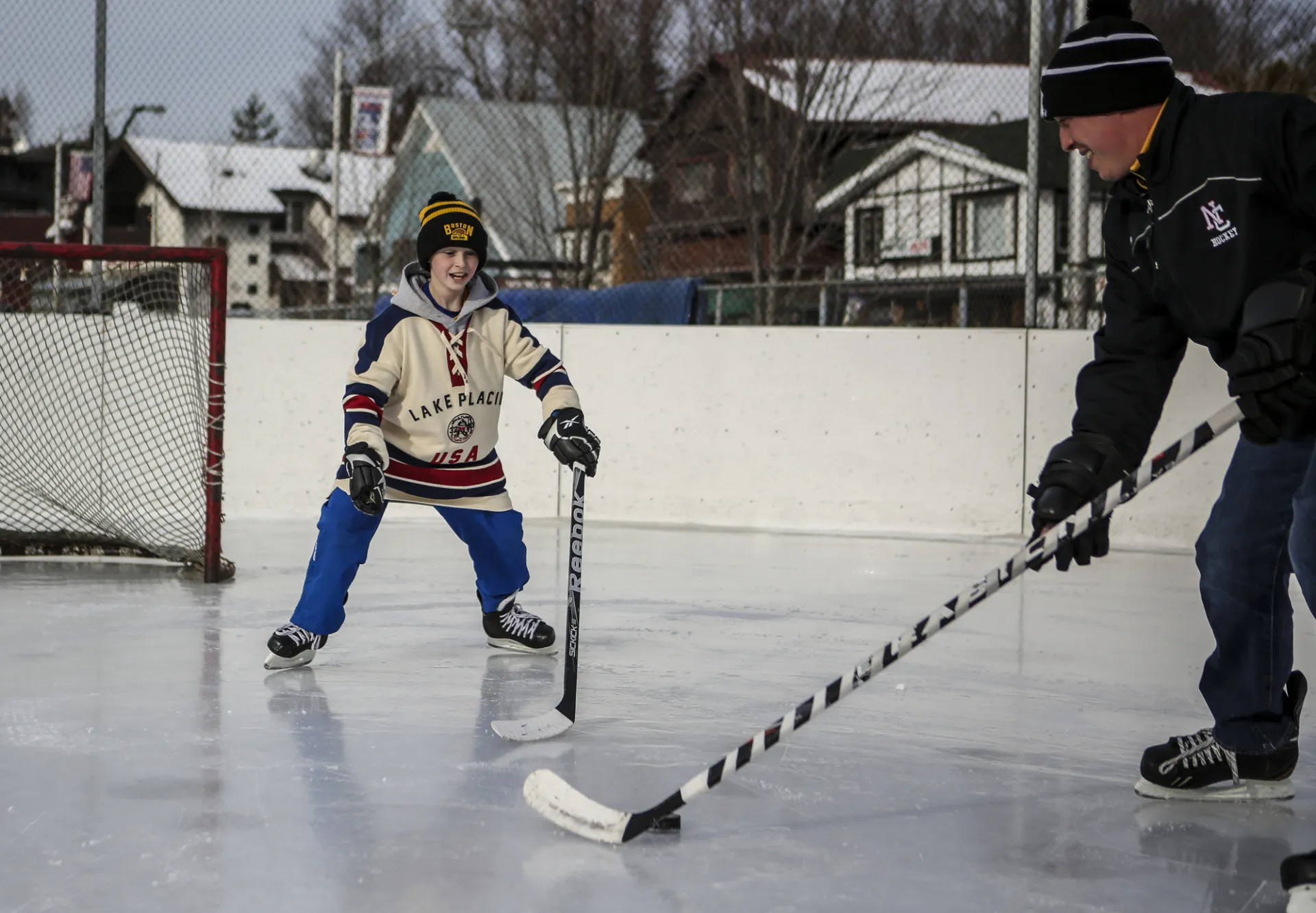 A father and son play hockey