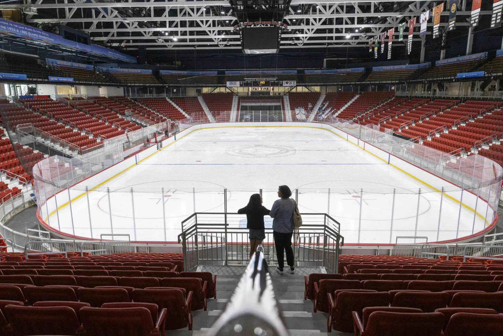 A mother and daughter look out at the remodeled 1980 hockey rink.