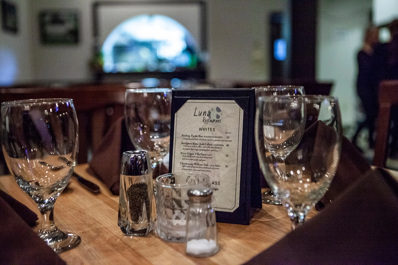 Wine glasses surround Luna Restaurant's drink list.