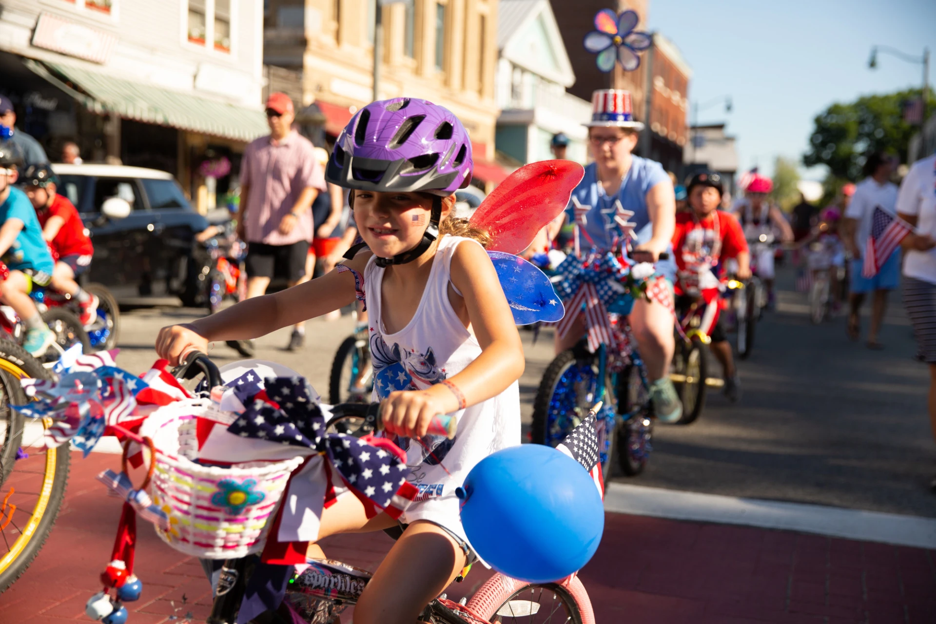 Kid rides a decorated bike in the parade