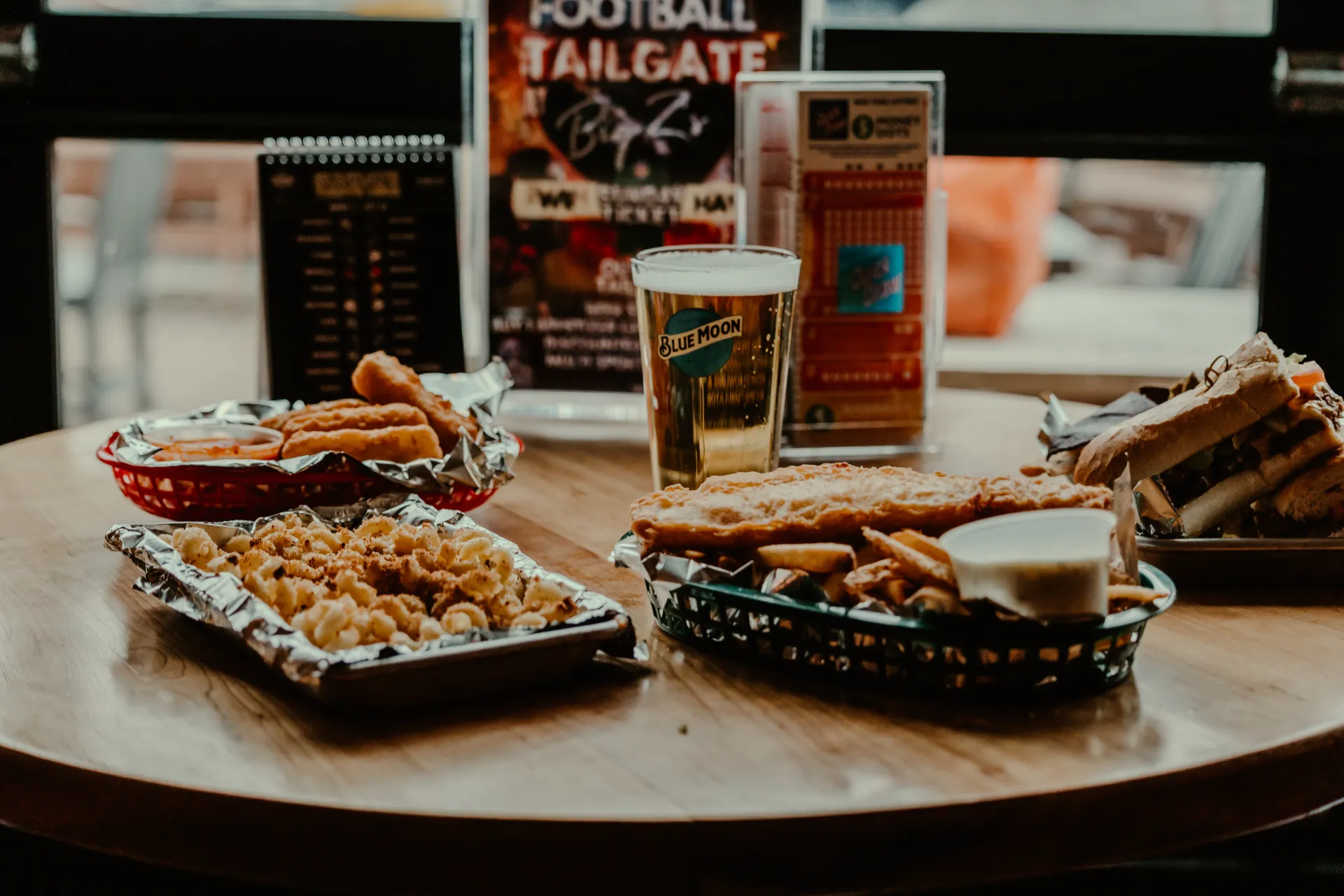 An assortment of foods on a table by the glass garage doors.  Photo Credit to A. Kelly.