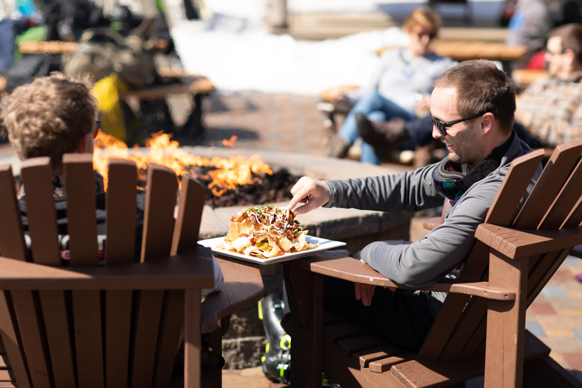 Enjoying a snack by the fireplace at the base lodge of Whiteface Mountain.