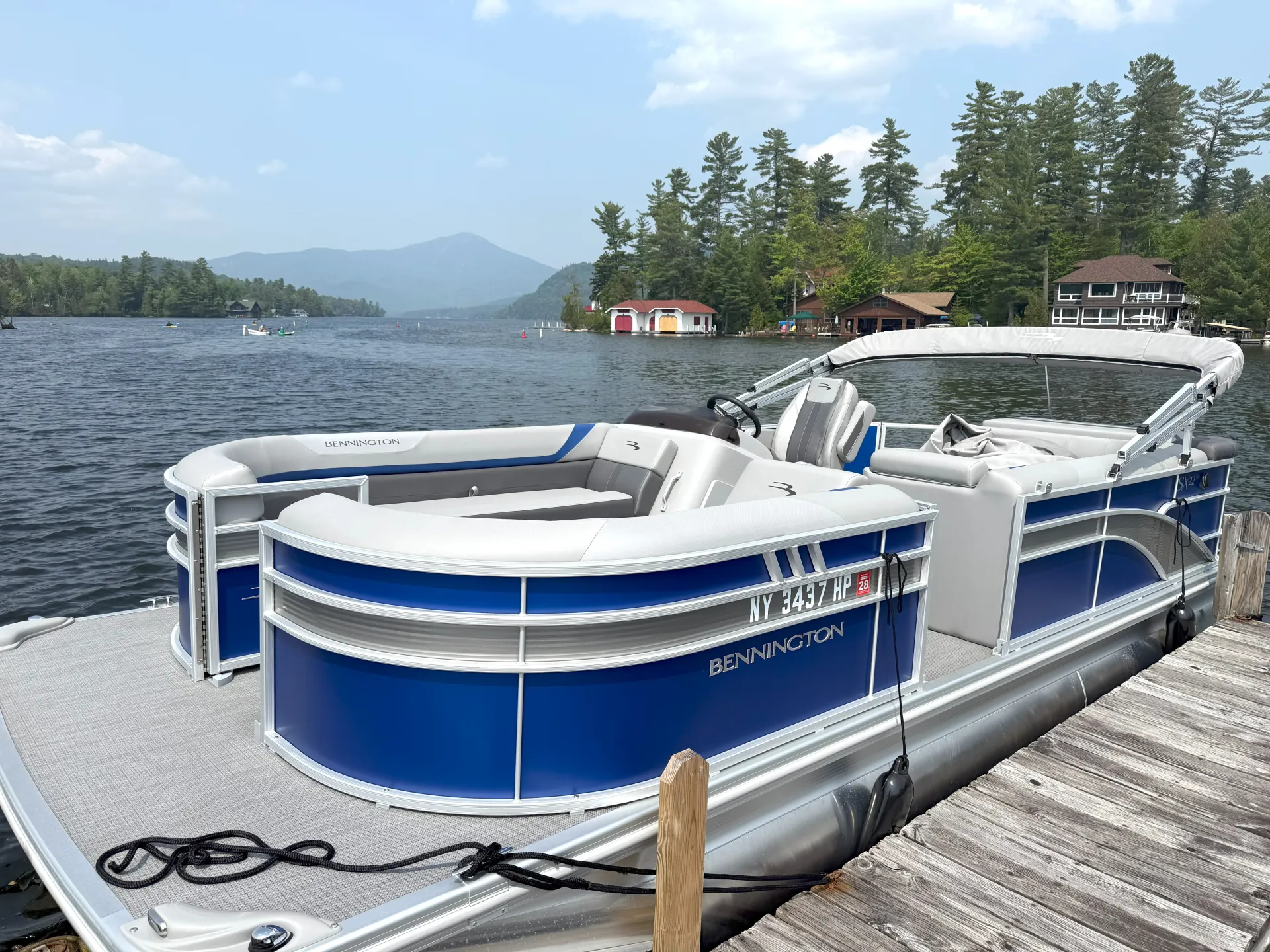 A blue pontoon boat is docked