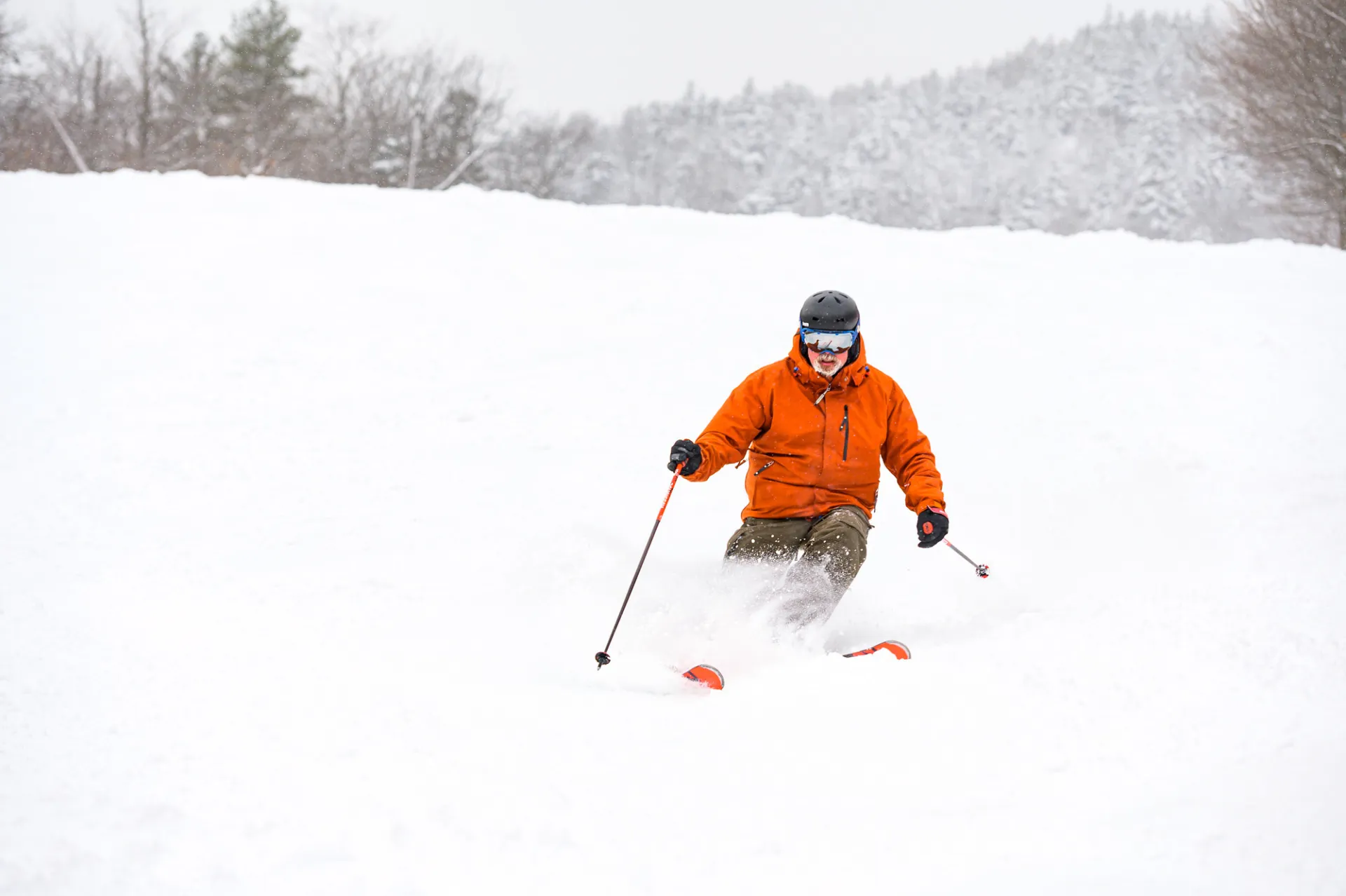 A skier on a snowy trail at Whiteface Mountain.