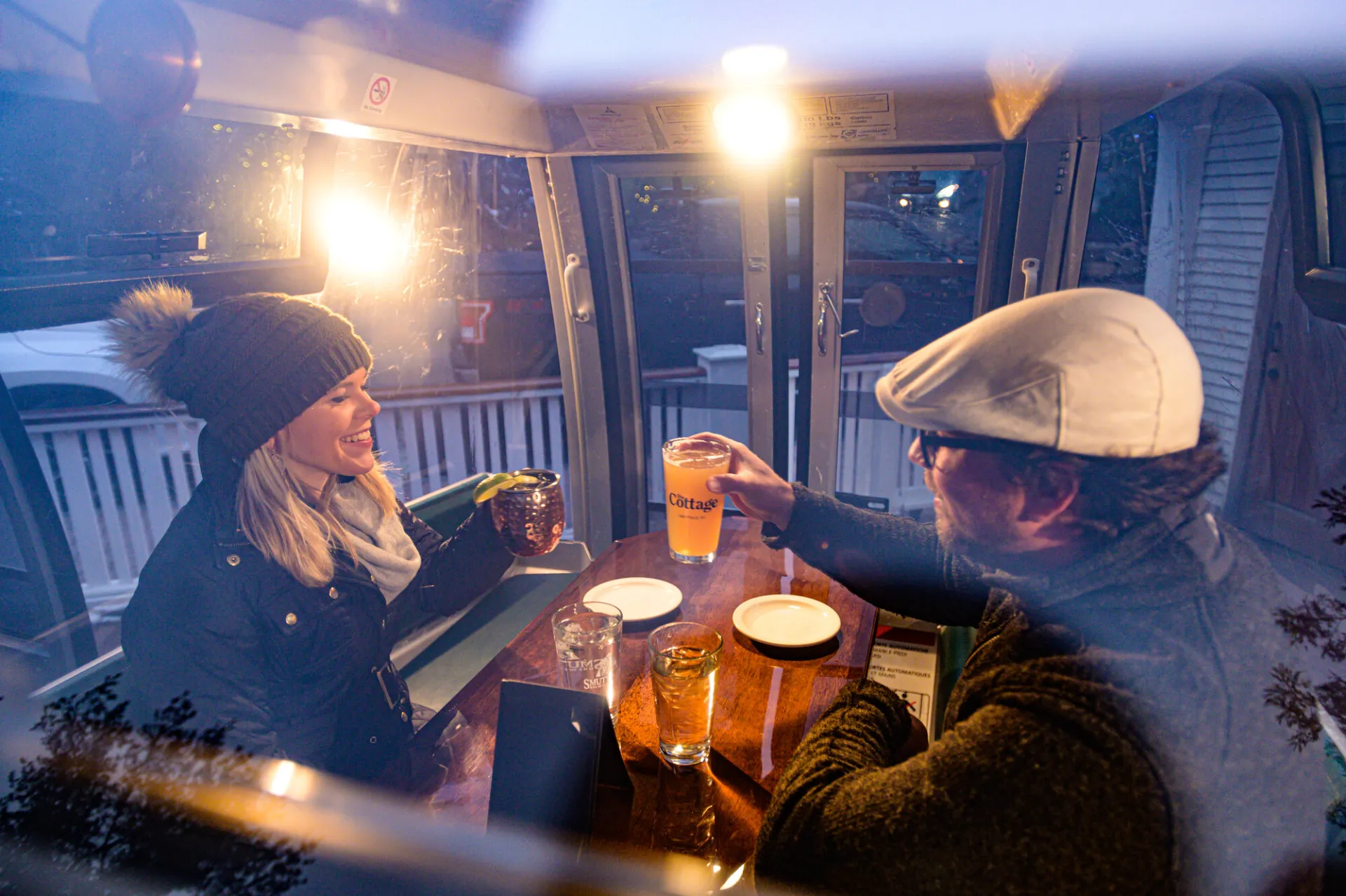 Man and woman inside gondola eating dinner
