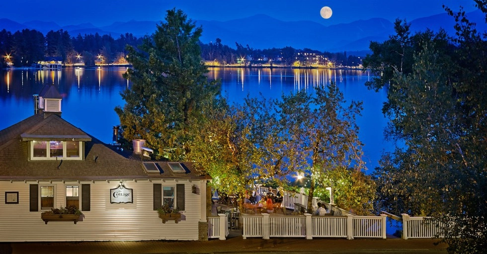 A view of The Cottage from up the hill at dusk .