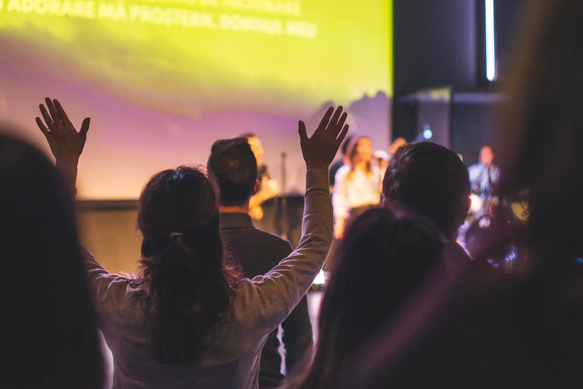A group of people sing at a worship service. 