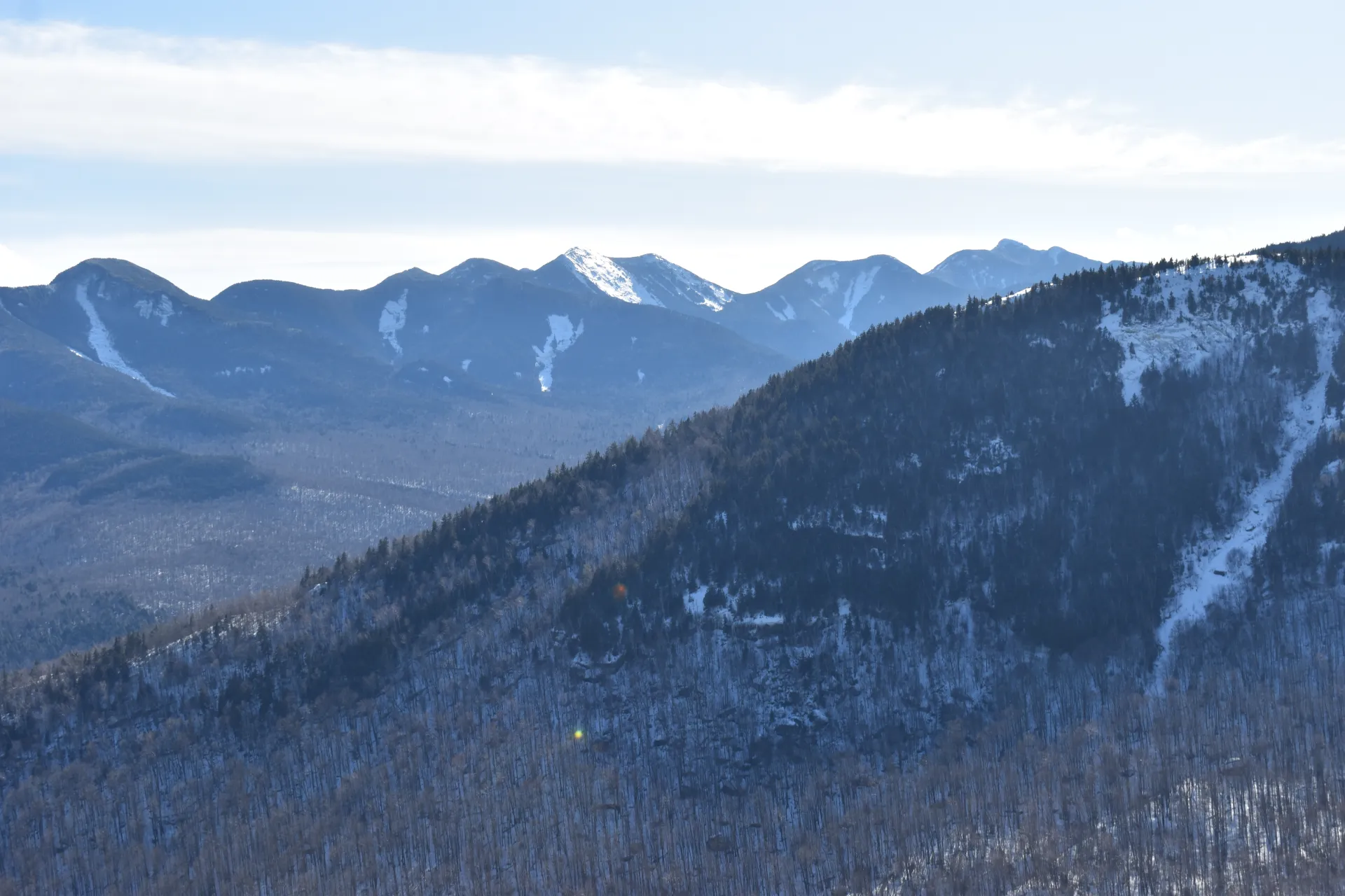 The view of mountains lightly covered in snow
