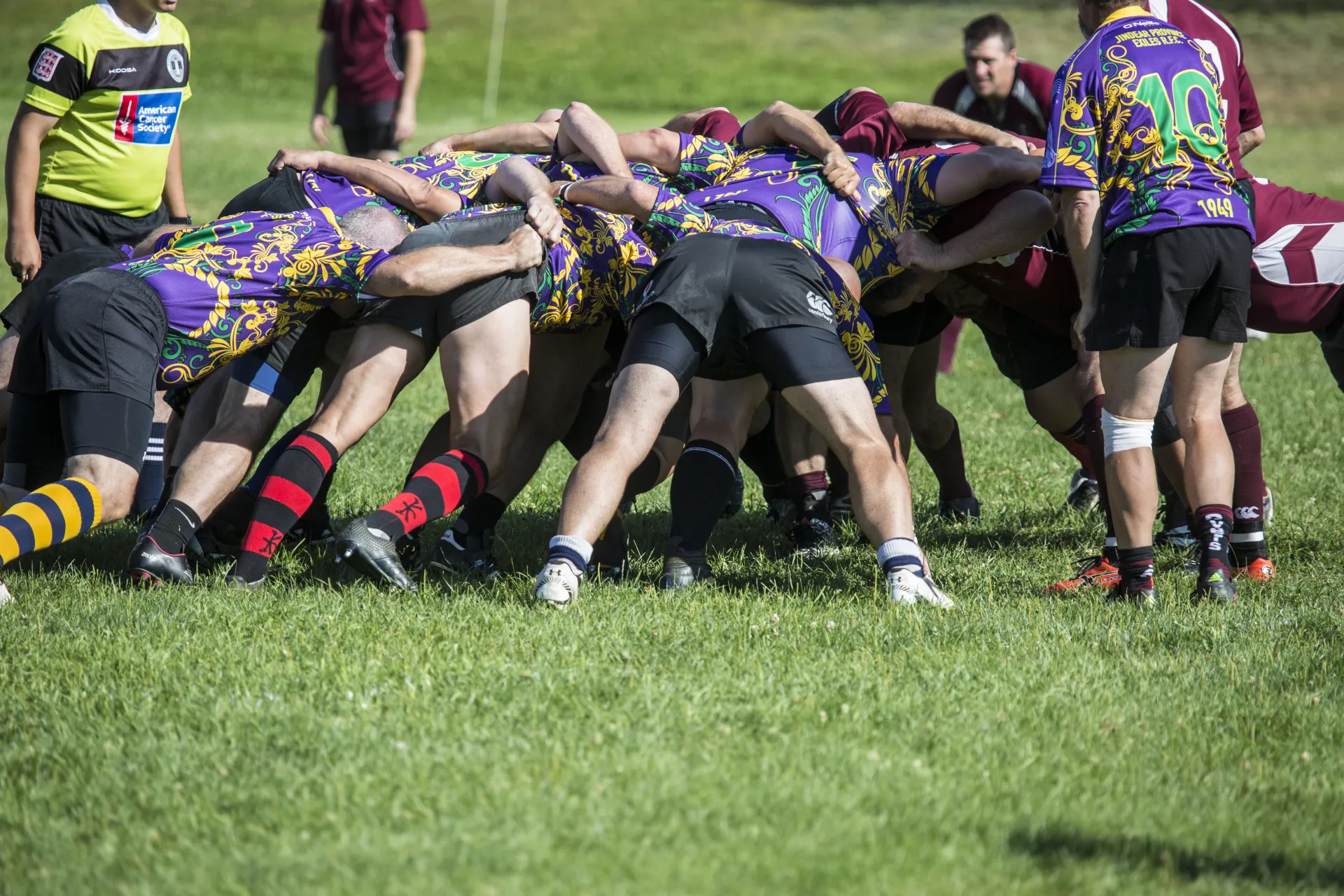 Players gathered in a tight huddle on the field 