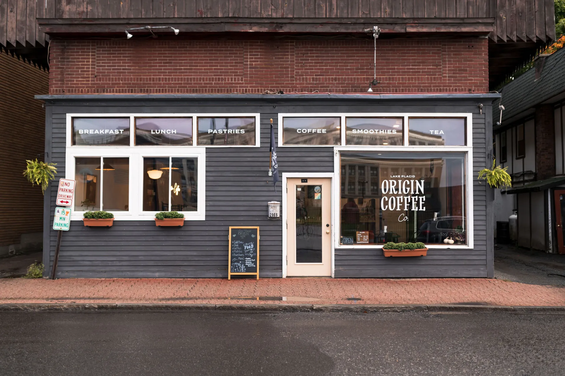 The blue and white exterior of Origin Coffee in Lake Placid