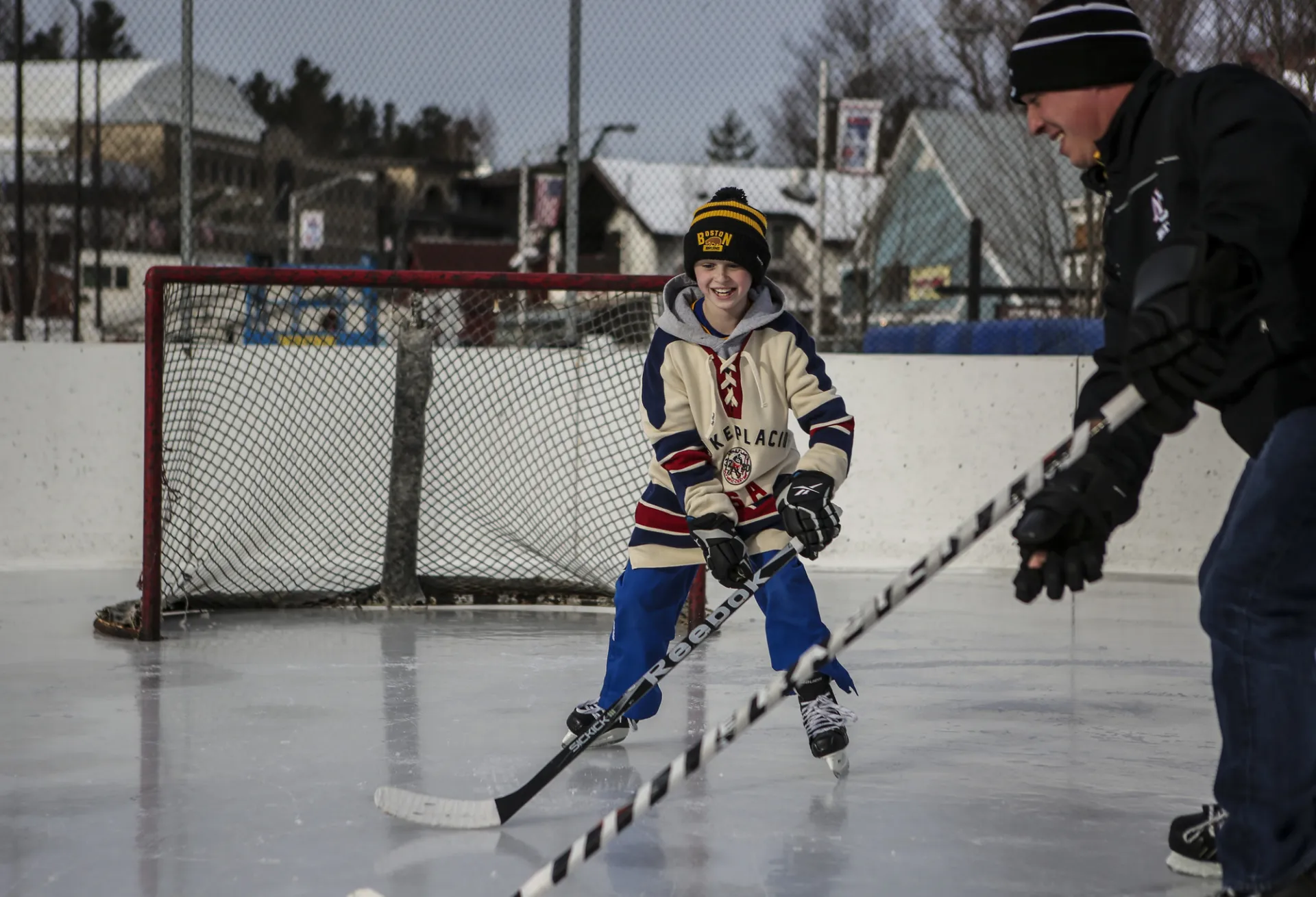 A father son duo play hockey in town.