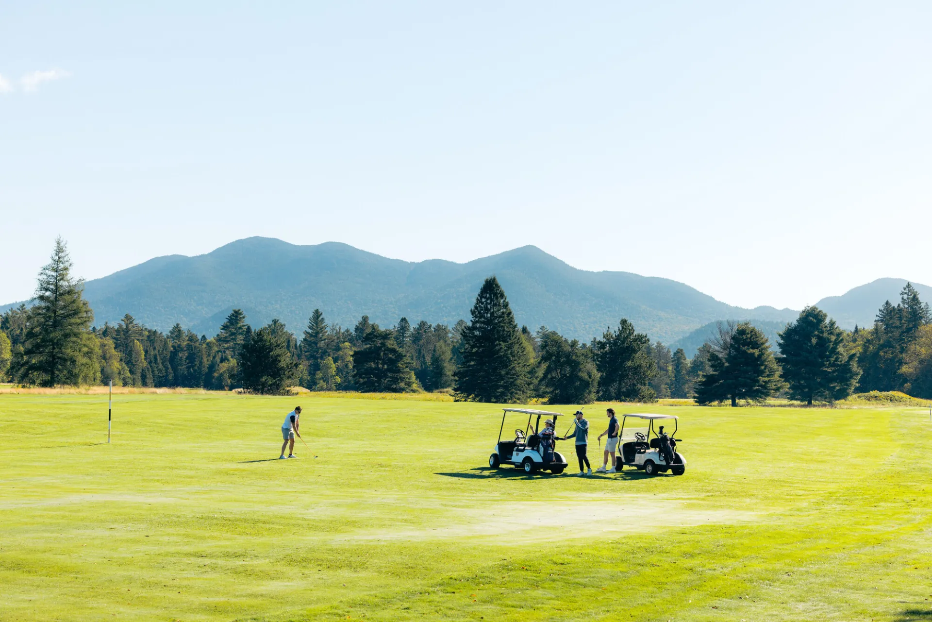 A group of golfers standing on a Lake Placid golf course.