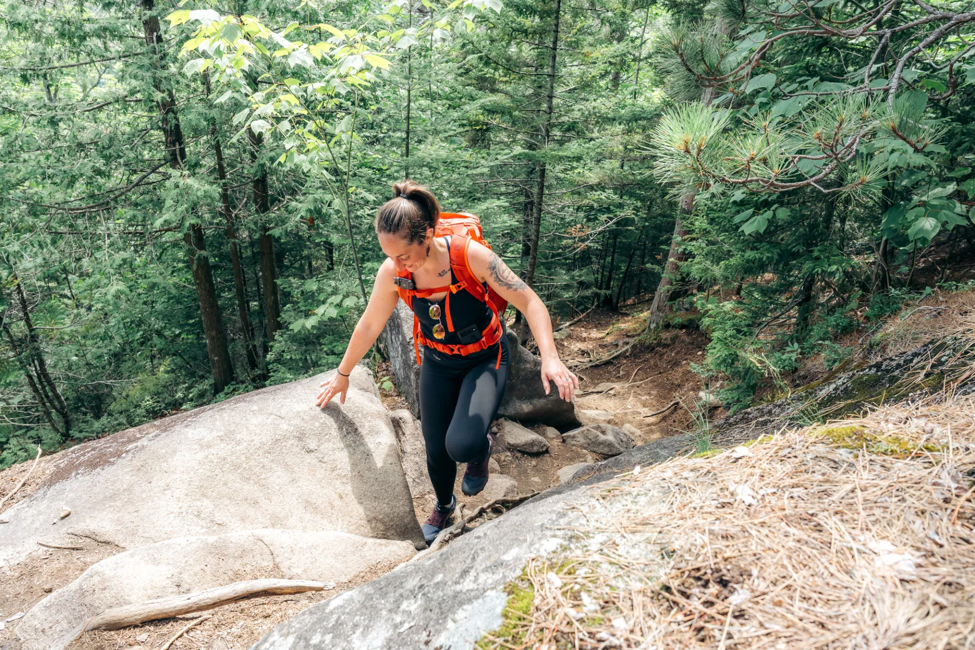 Hiker walks up rocky section of trail