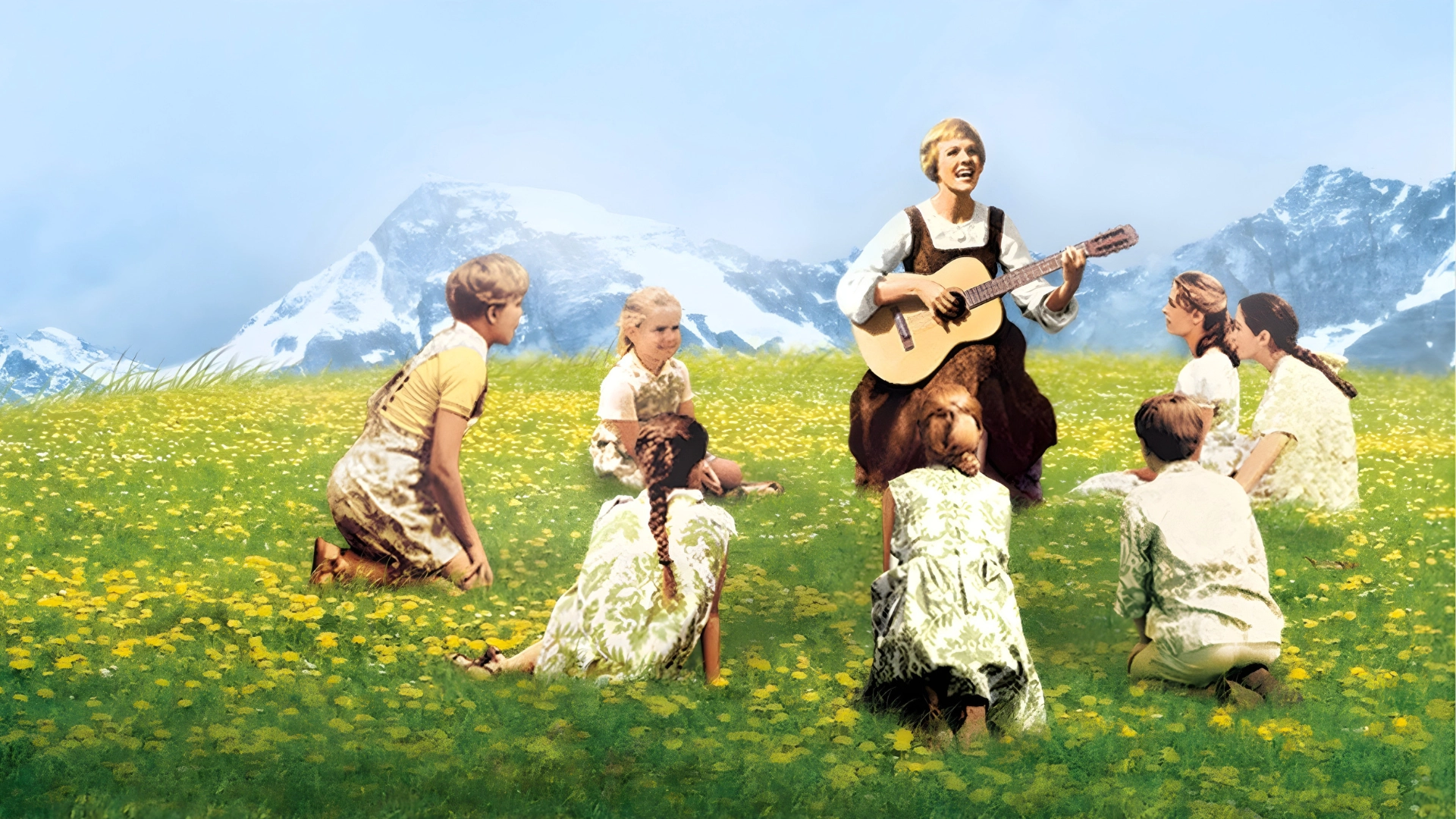 Maria from *The Sound of Music* sits in a sunlit, wildflower meadow playing a guitar and singing to children around her.
