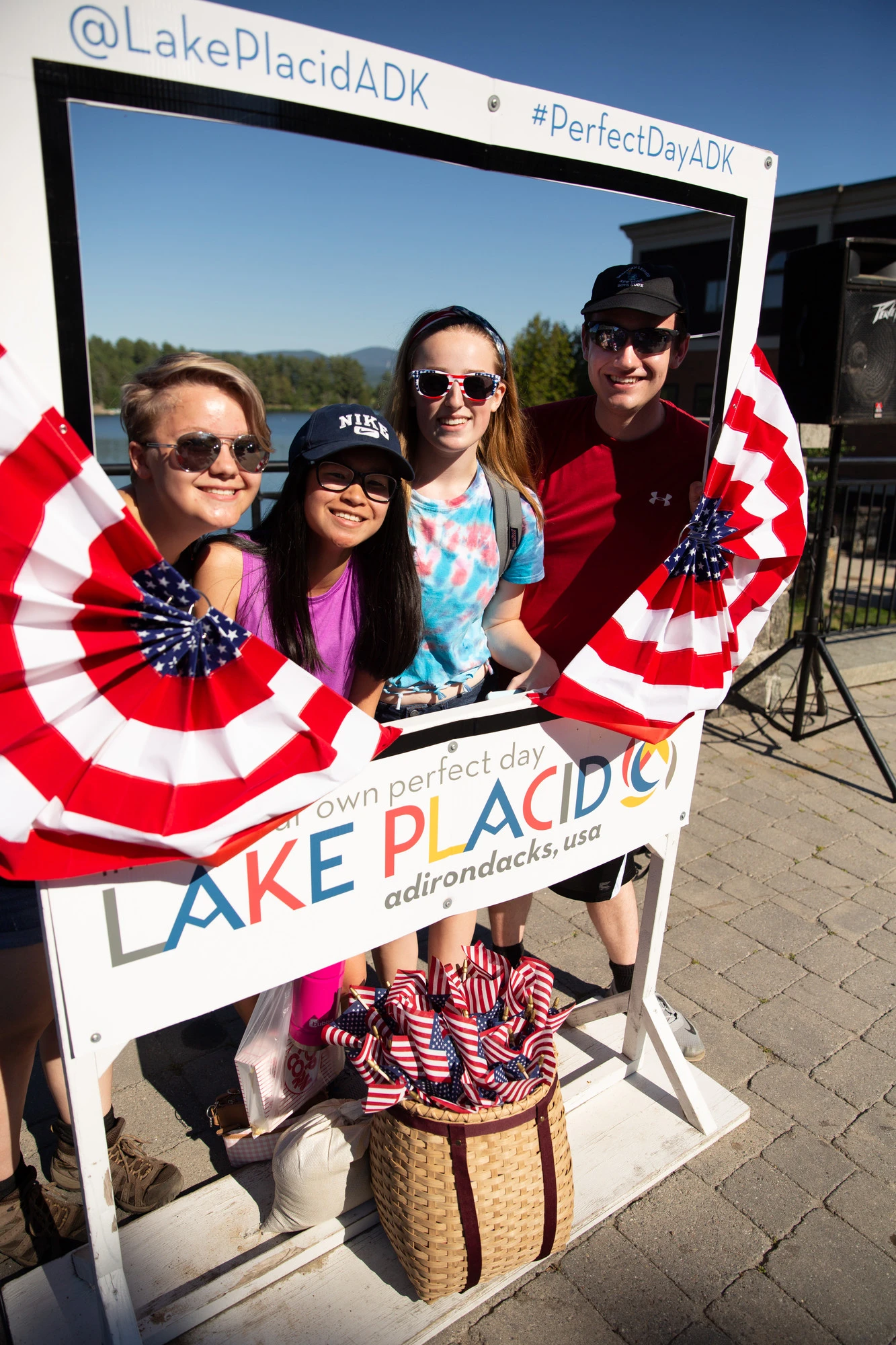 three teenagers pose for a photo in the Lake Placid selfie frame