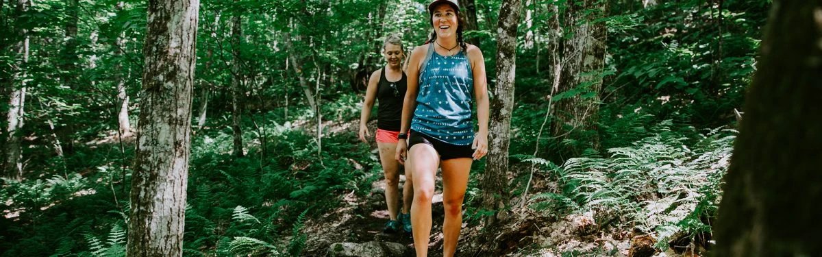 Two happy girls hike the trails on Whiteface Mountain.