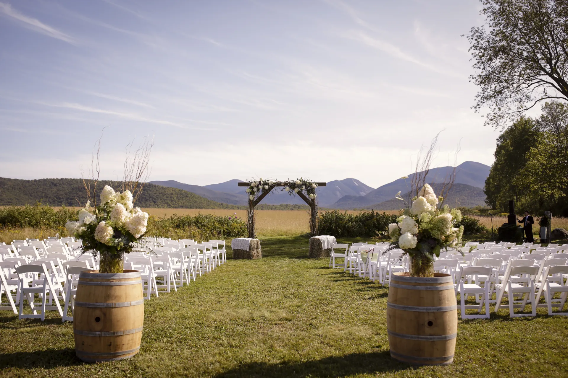 The wedding site with rustic alter adorned with hydrangeas and hay bales