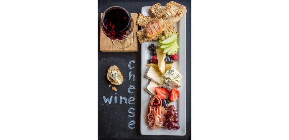 A wine and cheese board from above.