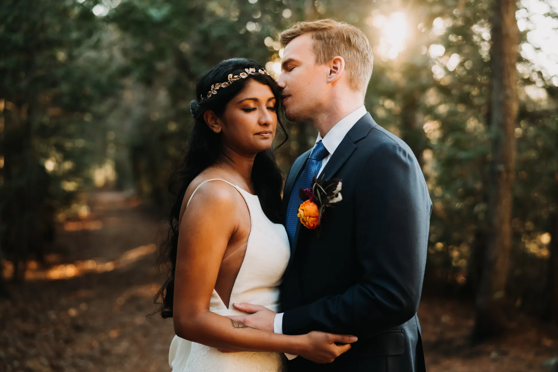 married couple holding it other on a trail