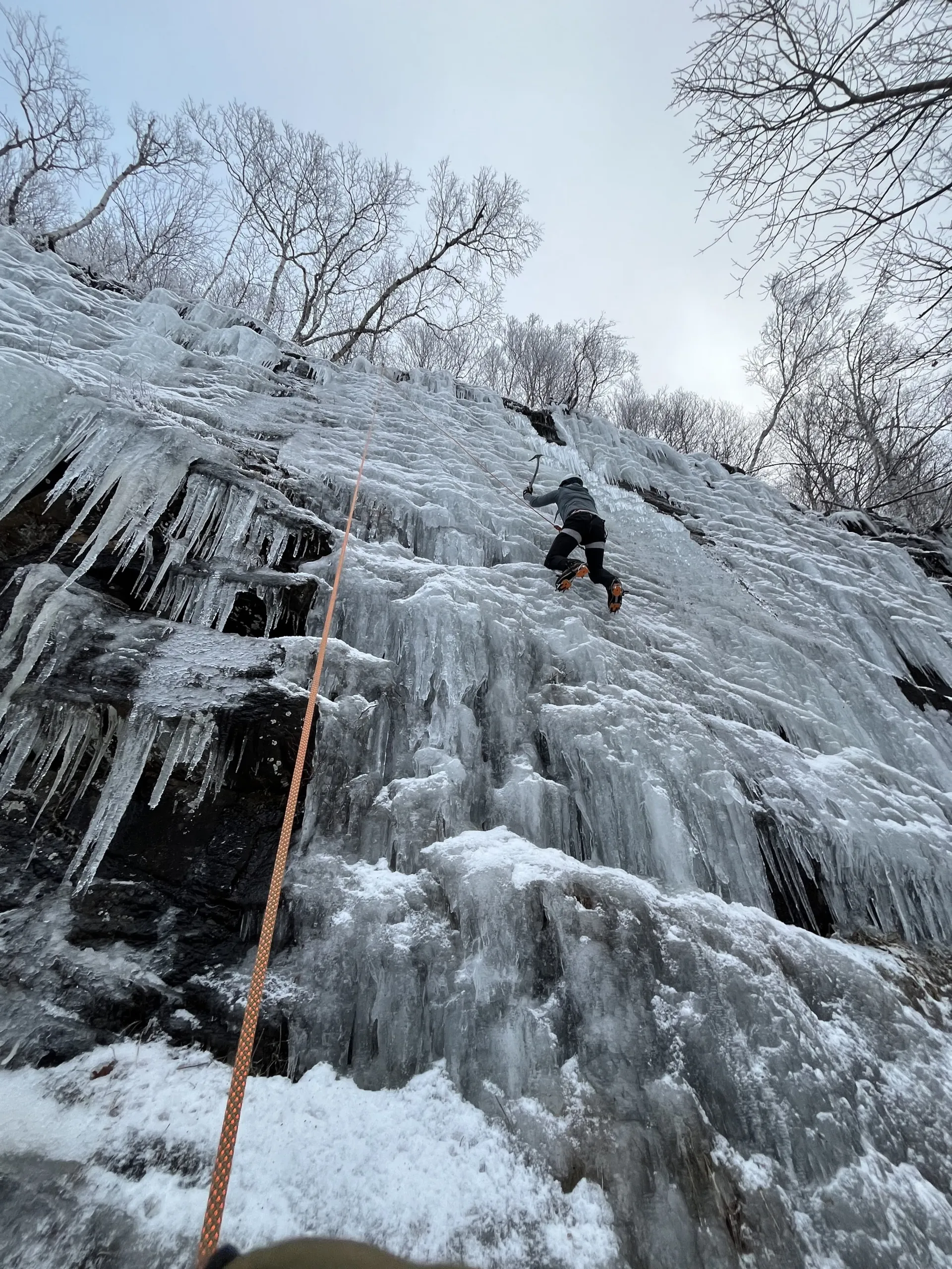 Looking up at a climber scaling an iceflow