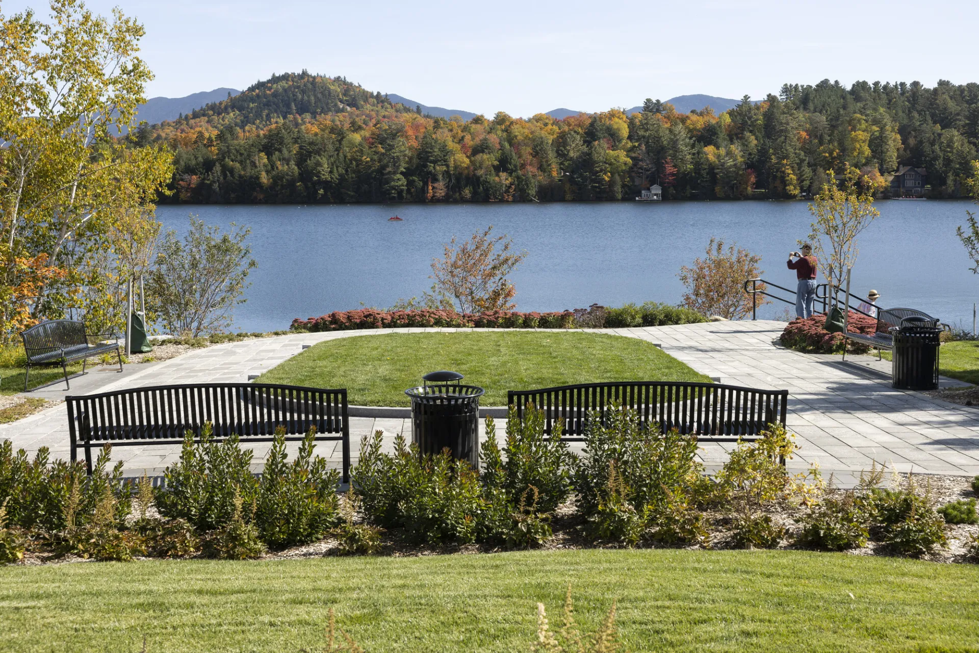 Park benches and green space at the edge of a lake