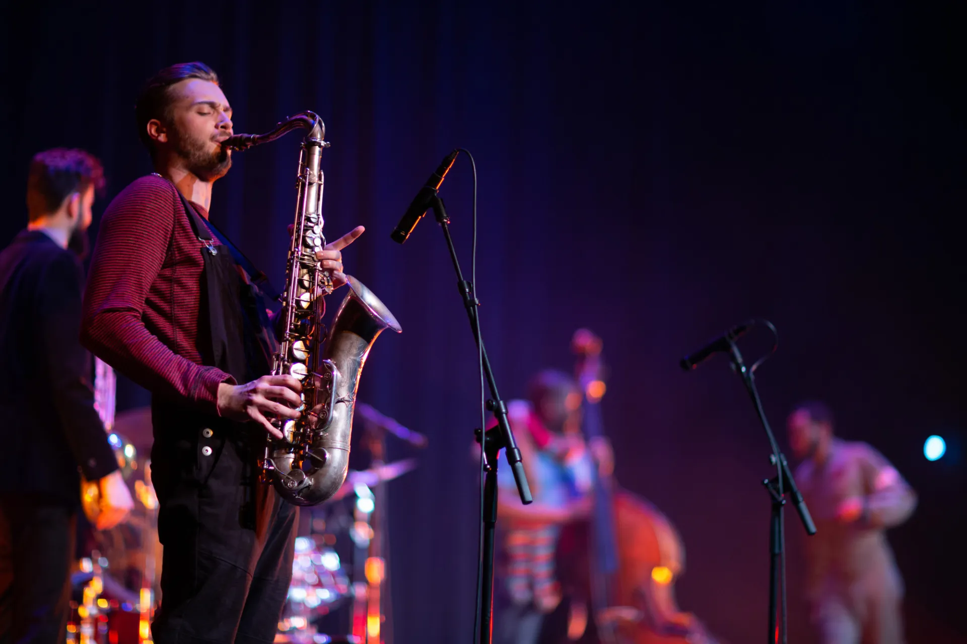 A saxophone player playing in a live band.
