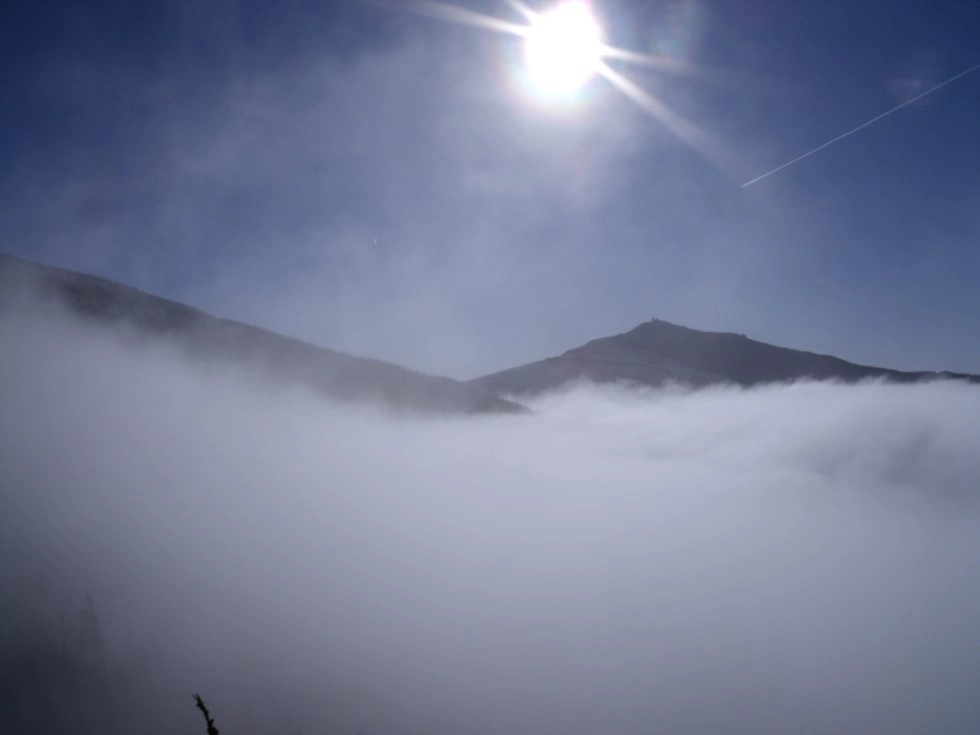 A wonderful shot of low clouds draping the peaks.