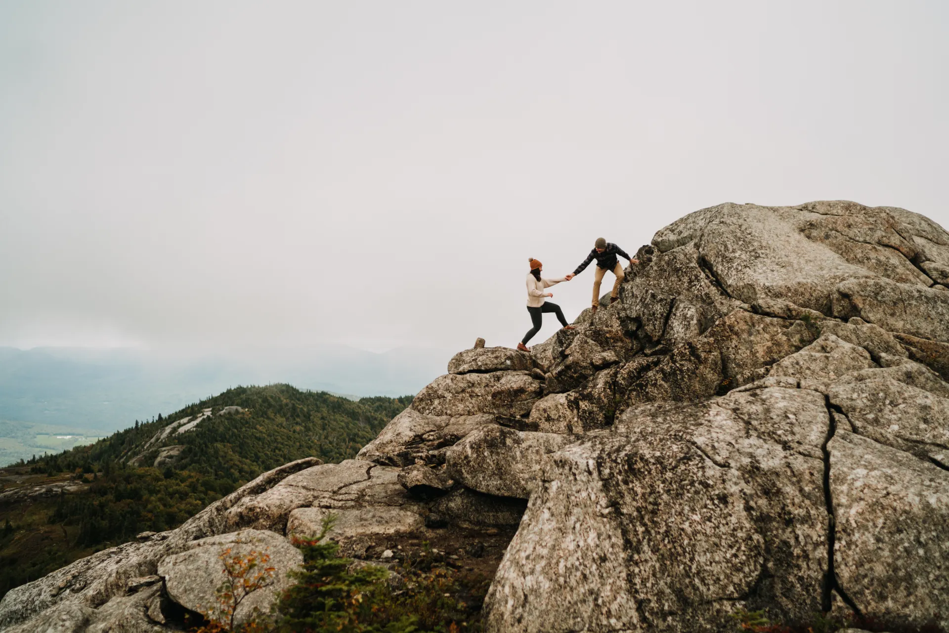 a couple climbs up a mountain