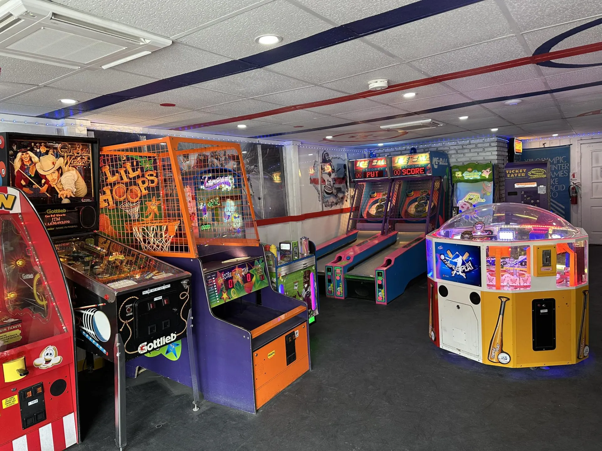 View of various arcade games in an interior room at The Penalty Box Arcade