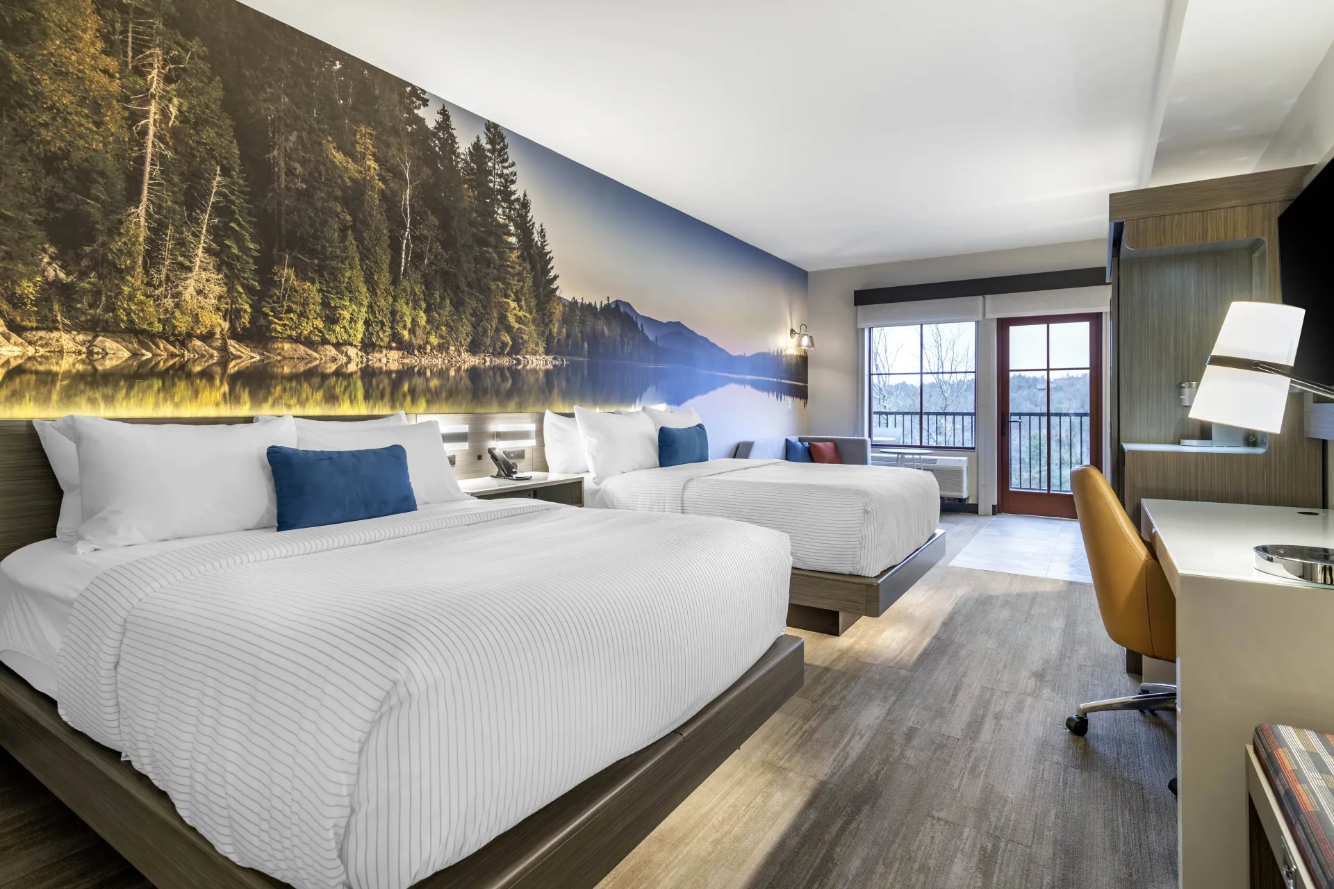 Large rooms with beautiful mountain and lake mural on the accent wall with fun pops of color and a modern feel.