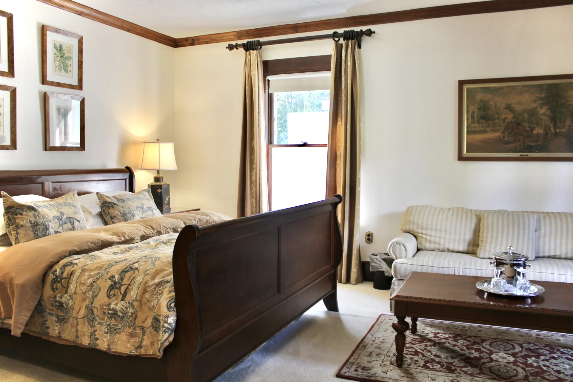 A large bright room with dark sleigh bed.