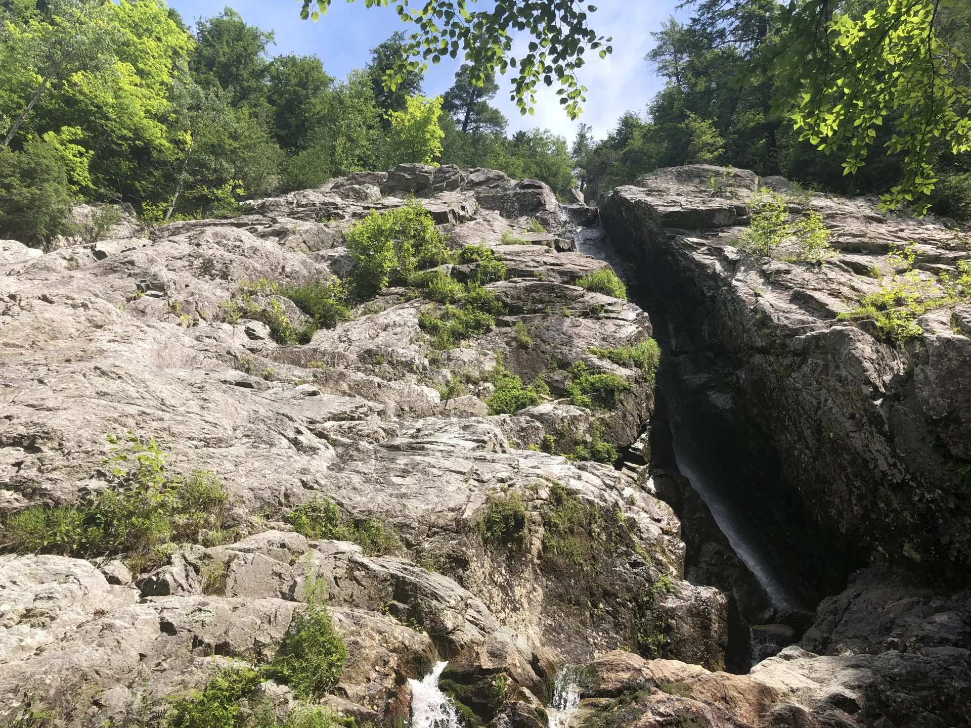 The rocky side of the falls on a sunny day