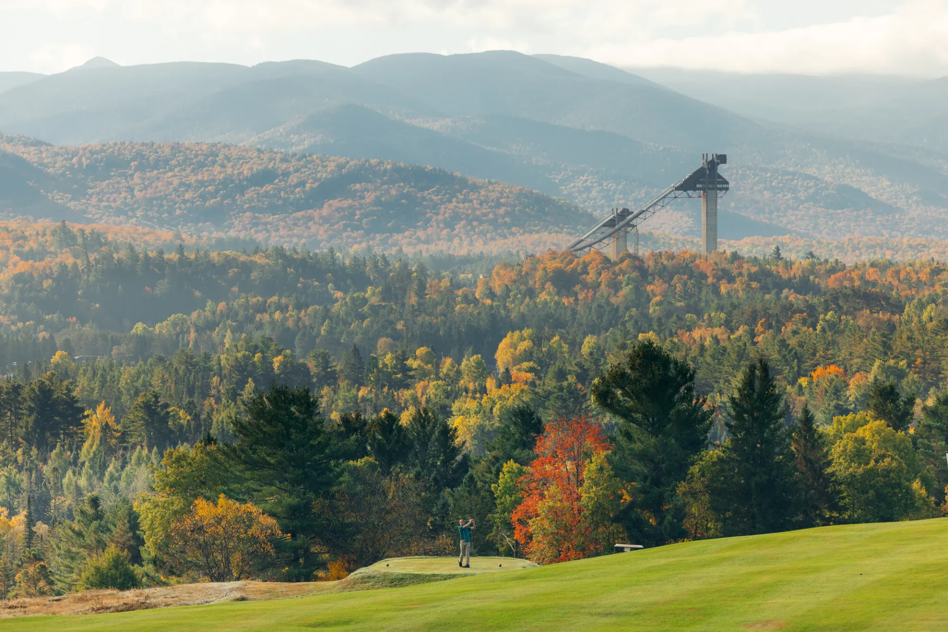 A golfer at the Lake Placid Club course in the fall