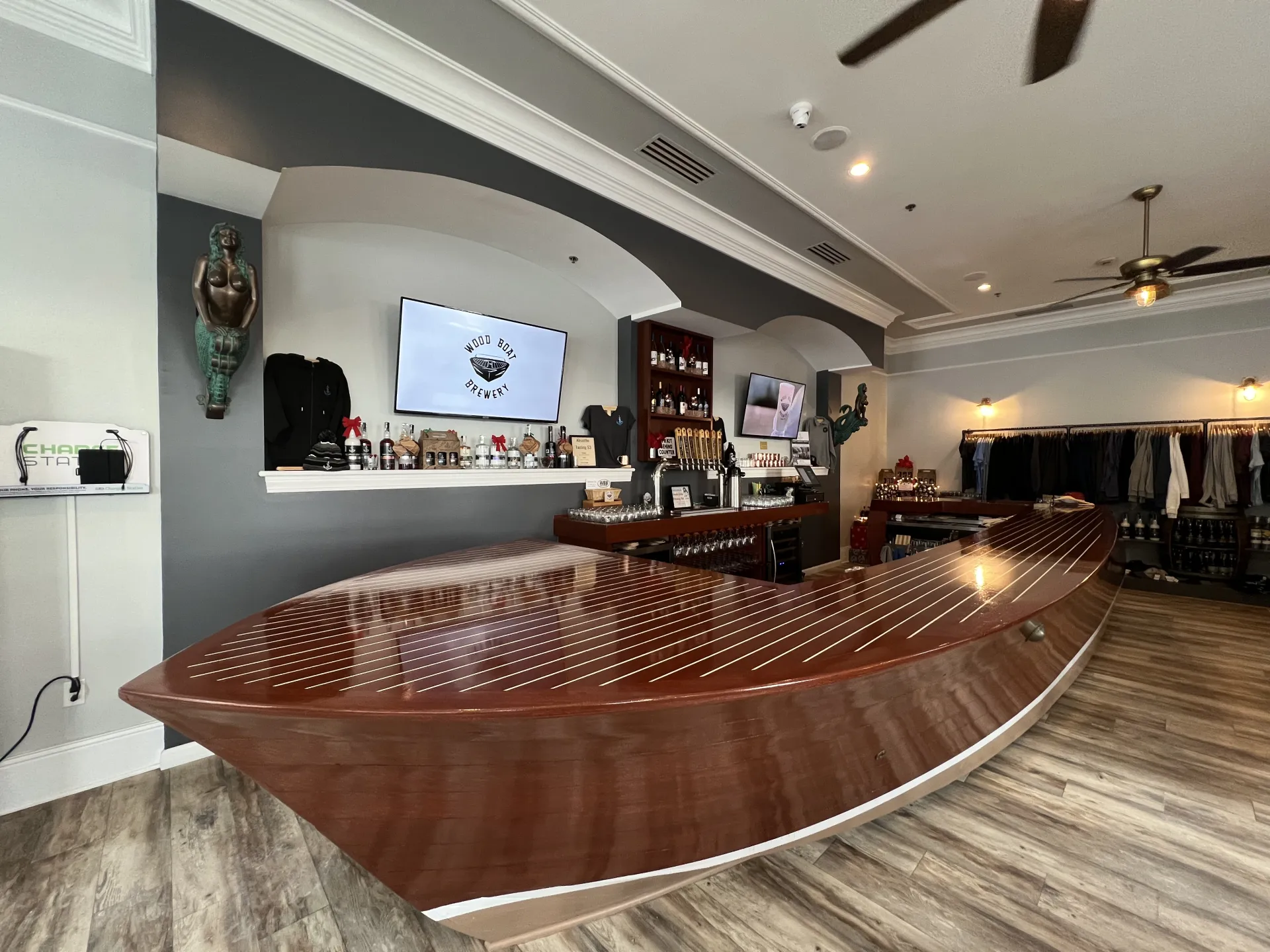 The dark stained wooden boat transformed into a bar in the tasting room.