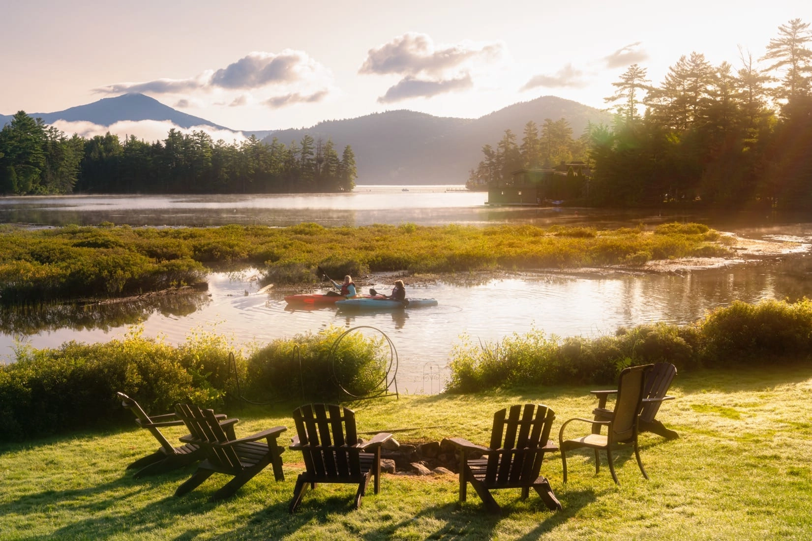 Two kayakers enjoy golden hour on the water.