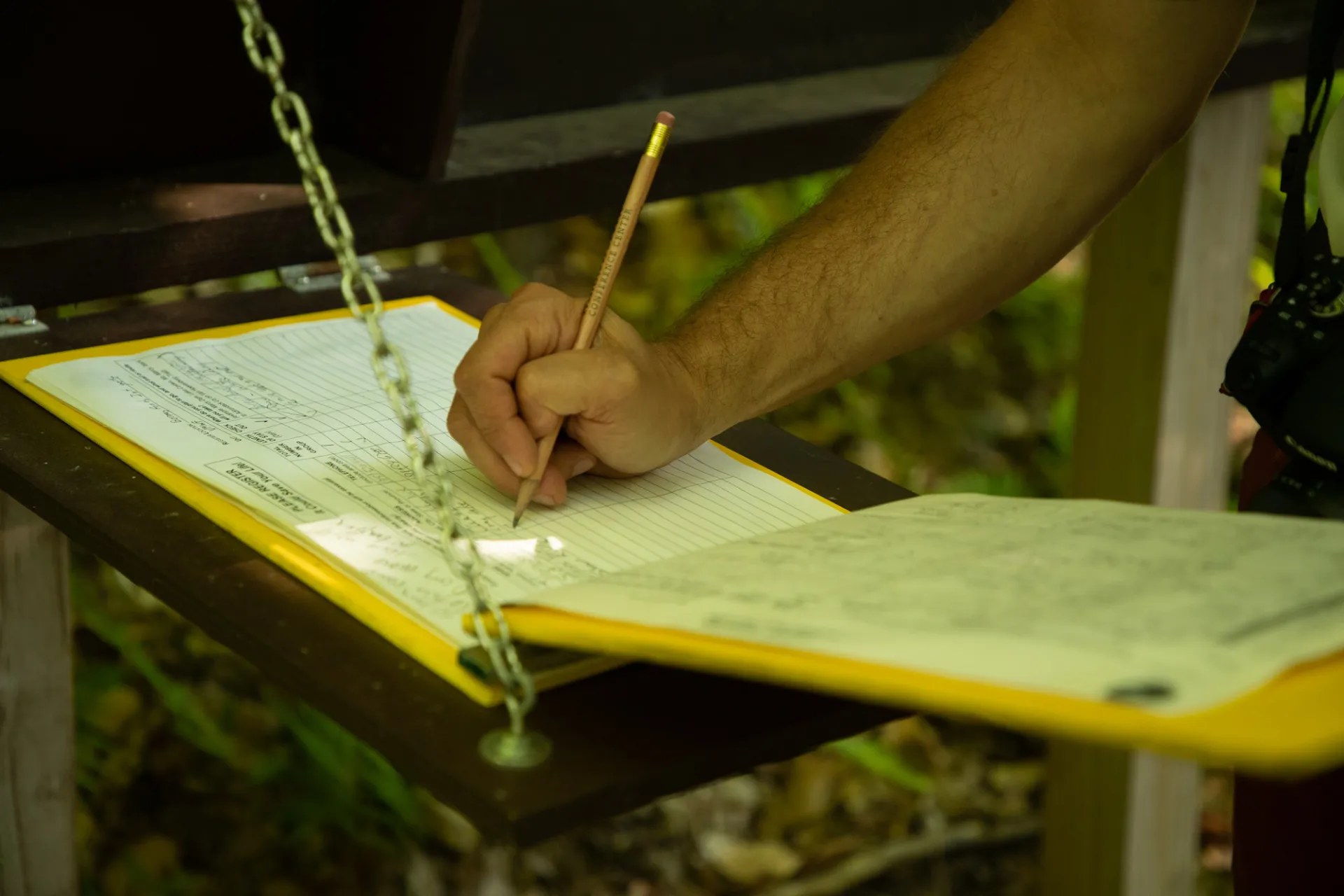 Someone signing in at a trailhead