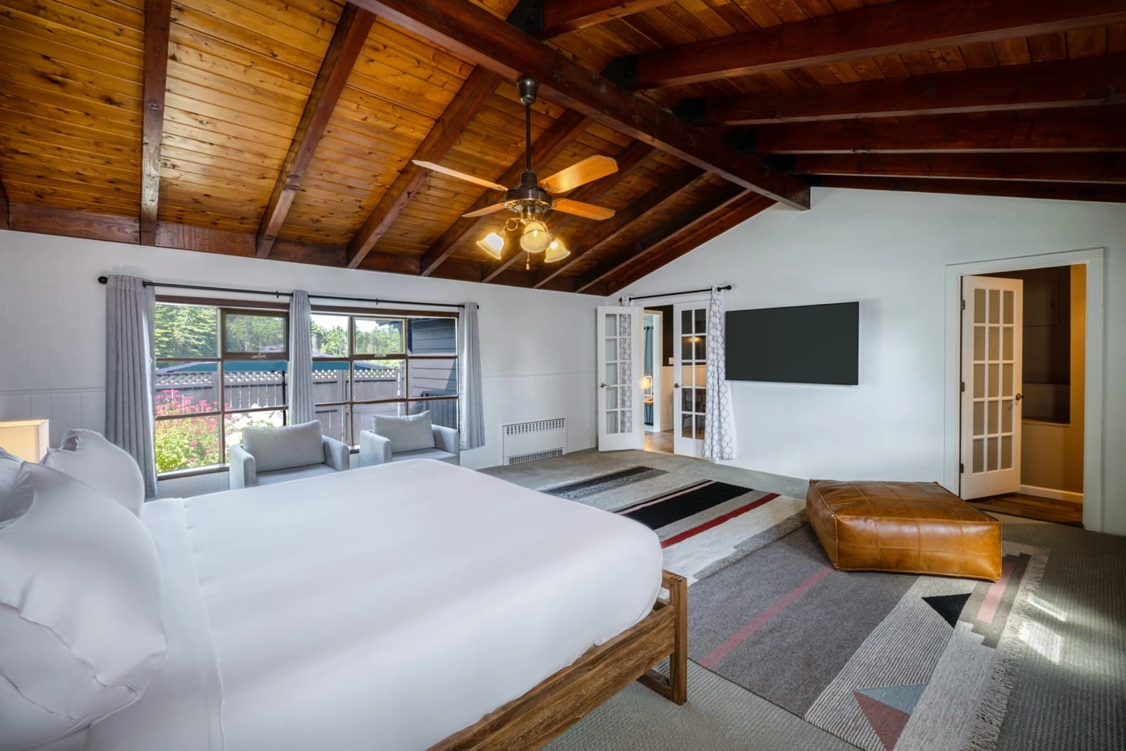 The large room with high ceilings, paneled with wood and lit with warm lights.