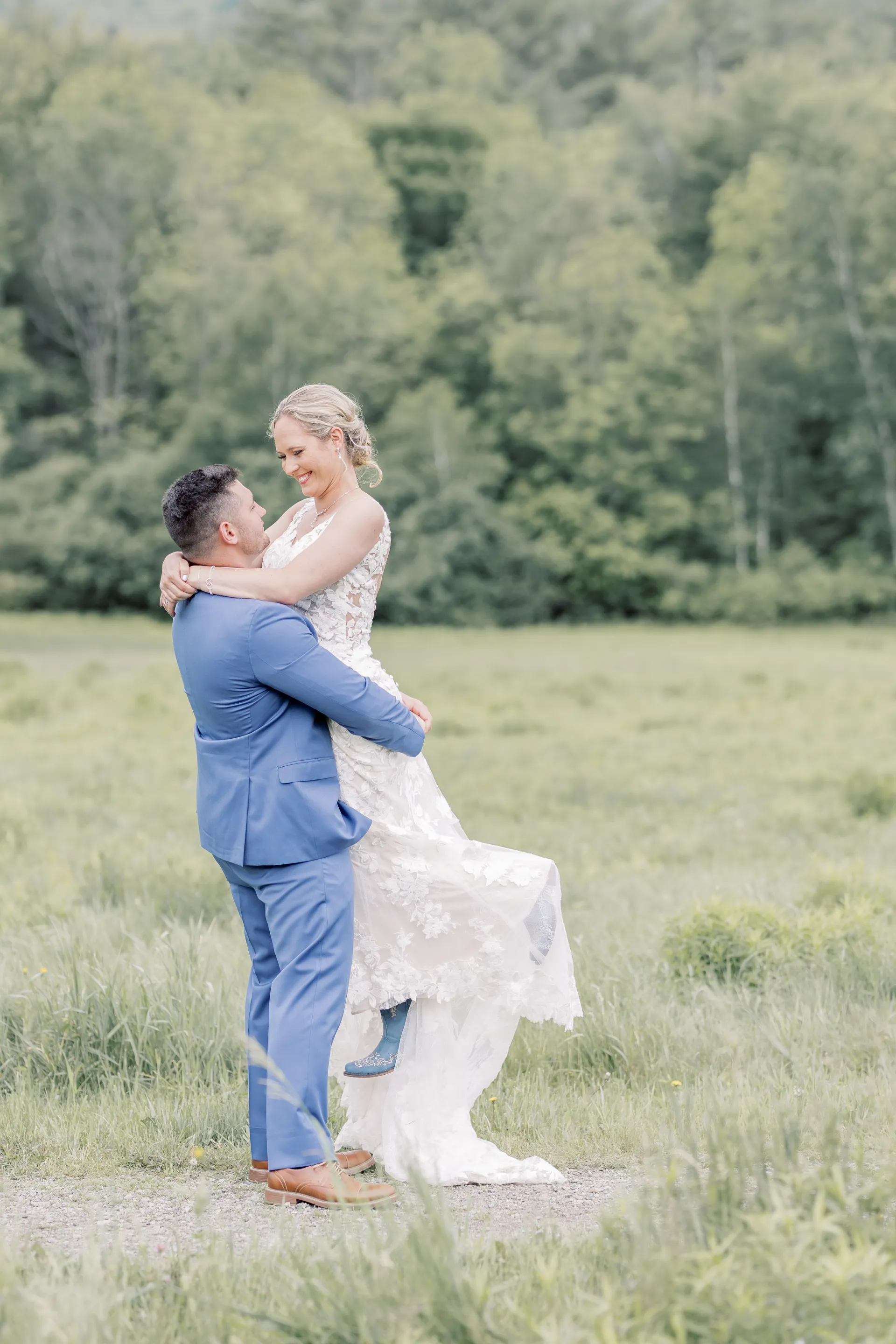 Groom holds bride in the air and spins