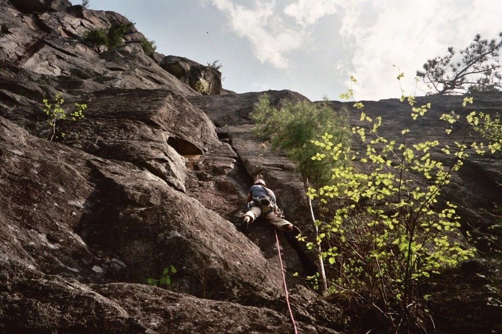 Someone climbing up a rock climbing roiute