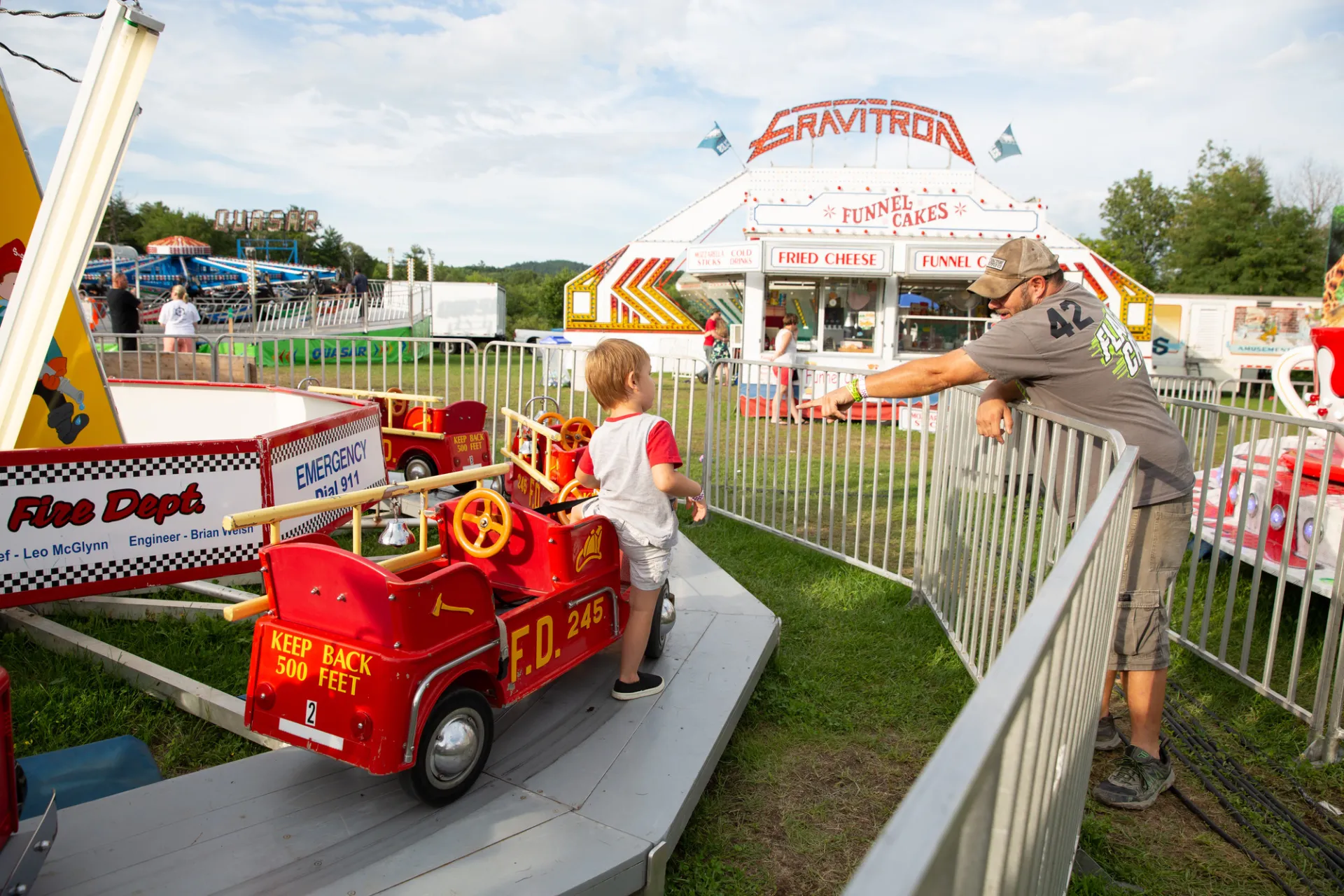 Man reaches out to child on amusement park ride
