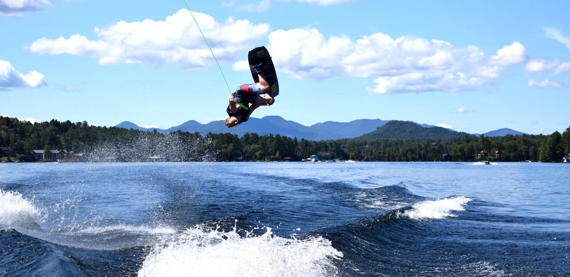 A wake boarder does a flip