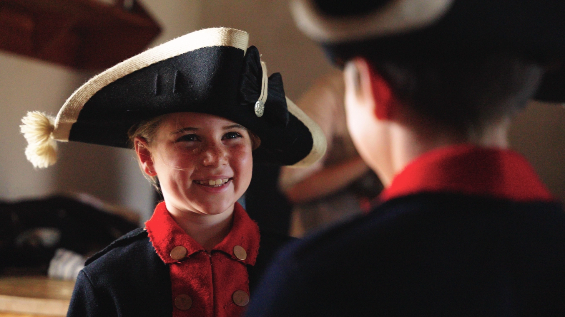Kids dressed up in period clothing smiling