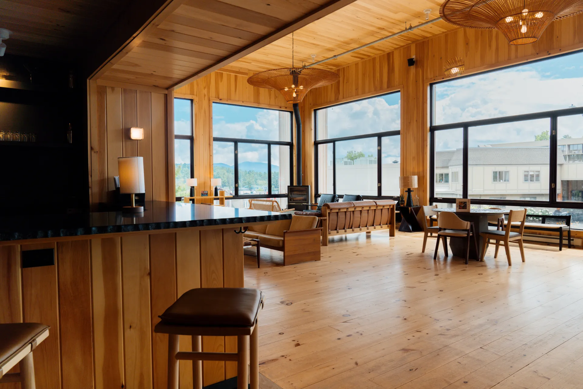 A view from the corner of the bar looking into the great room and the walls of large windows.